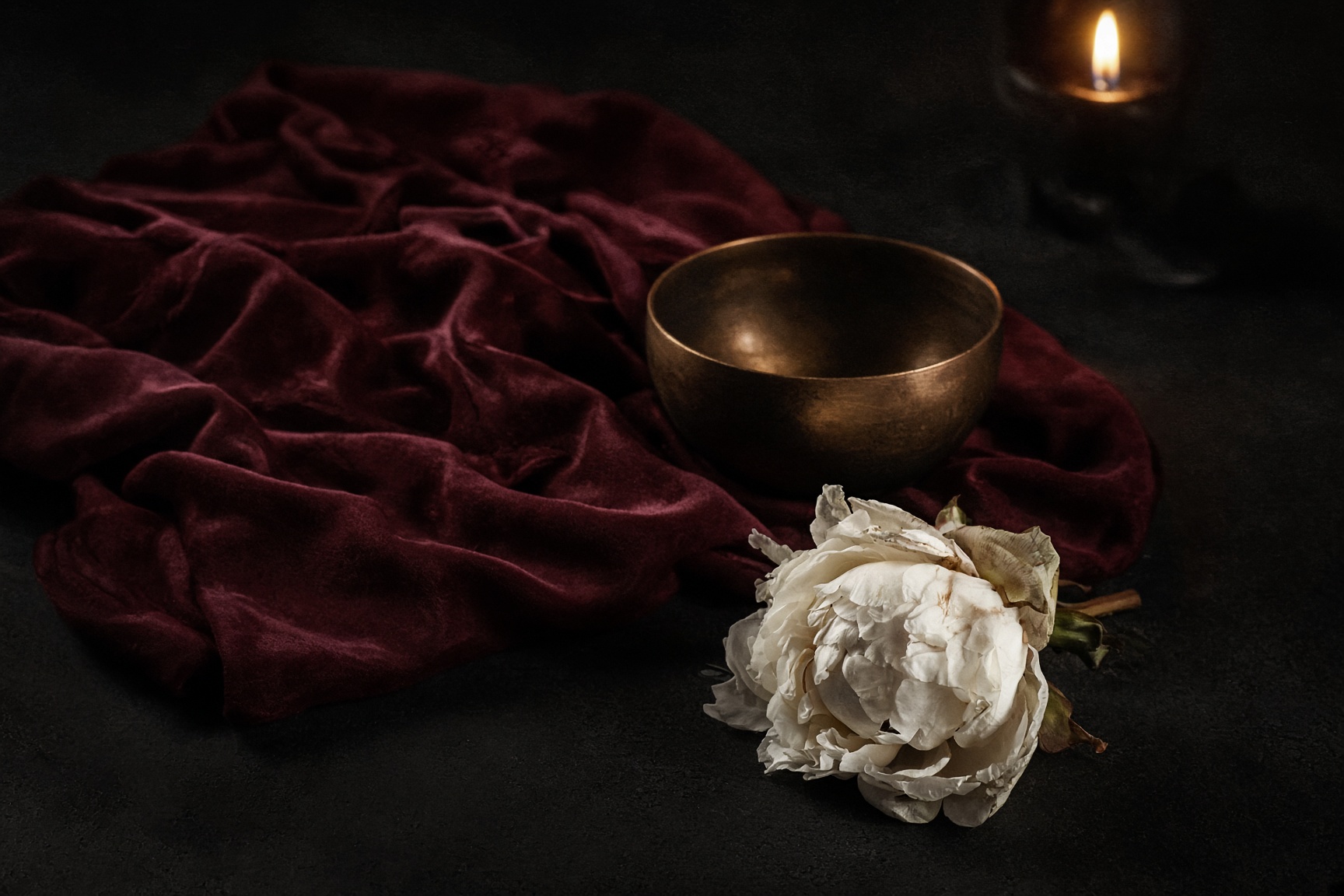 Placeholder photograph [IMAGE]: burgundy velvet, a bronze bowl, a wilting peony